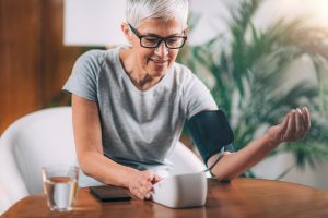 Woman Measuring Blood Pressure at Home